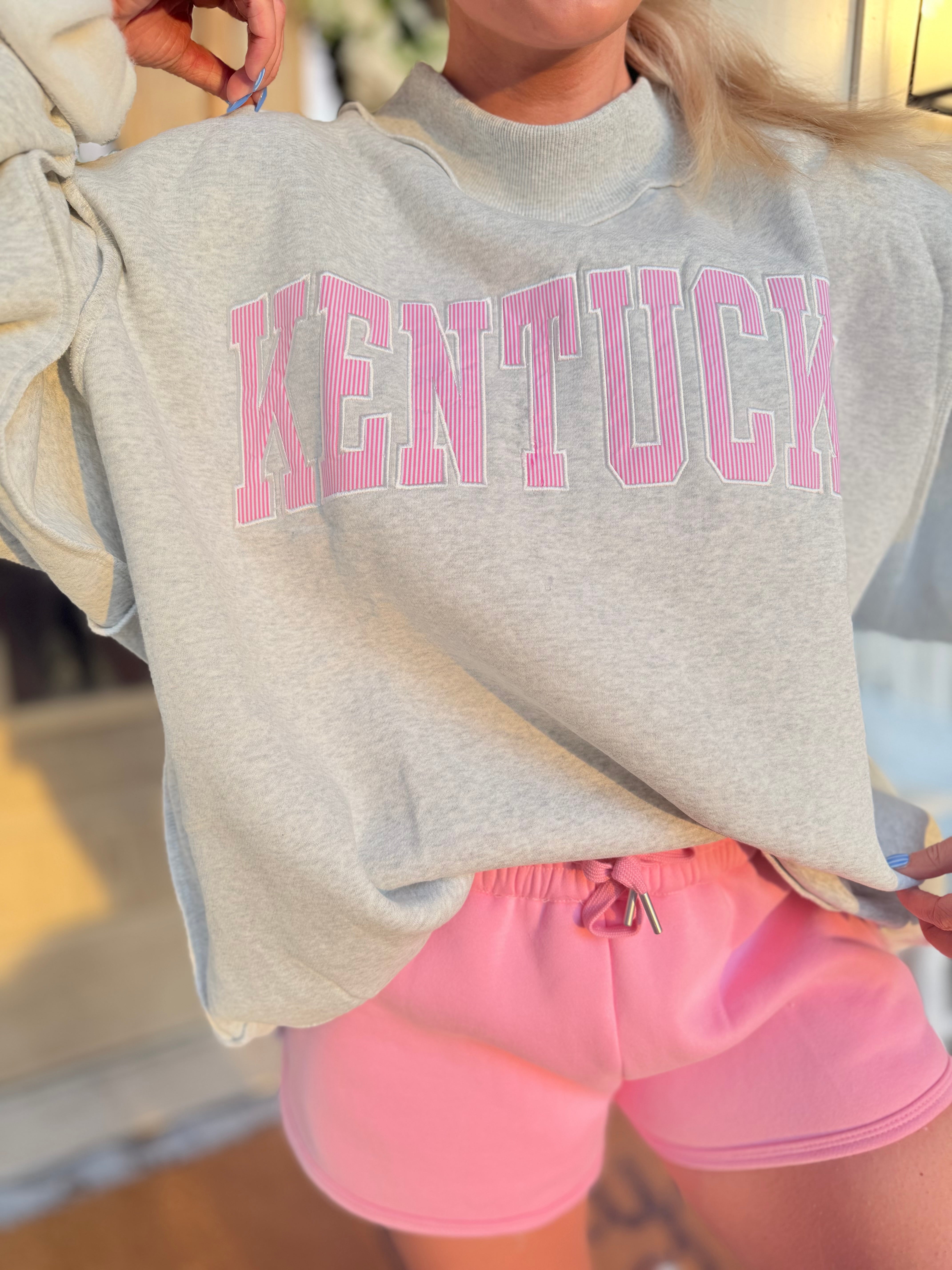 Kentucky Pink Striped Mock Embroidered Sweatshirt from BUCKET LIST 137 Graphic Sweatshirts, featuring pink stripes and embroidered details.