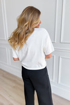 THINGS BETWEEN Venus short sleeve button-up top in light fabric, casual style, shown with collar and button-down front.