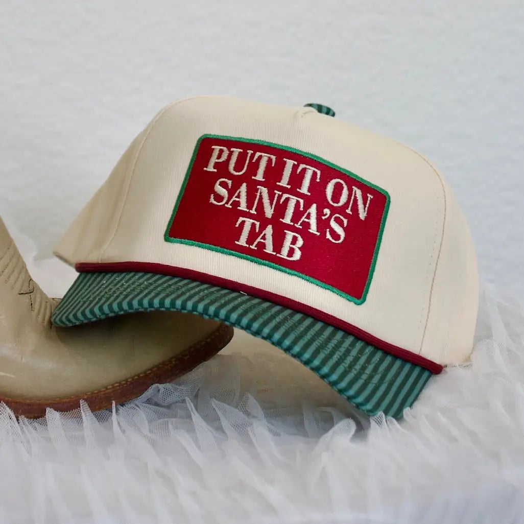 Put It On Santa's Tab Hat by SUMMER TEES, a festive red and white Christmas-themed hair accessory with playful holiday design.