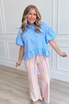 Light blue Maggie ruffle hem top from ENTRO, 105 casual tops collection, featuring a stylish ruffled detail and relaxed fit.