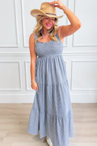 Baevely Painter Gingham Midi Dress displayed on a hanger, showcasing its stylish pattern and midi length for dressy occasions.