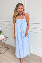 Sophie blue gingham printed maxi dress by PEACH LOVE featuring a flowing design and sleeveless style, perfect for dressy occasions.