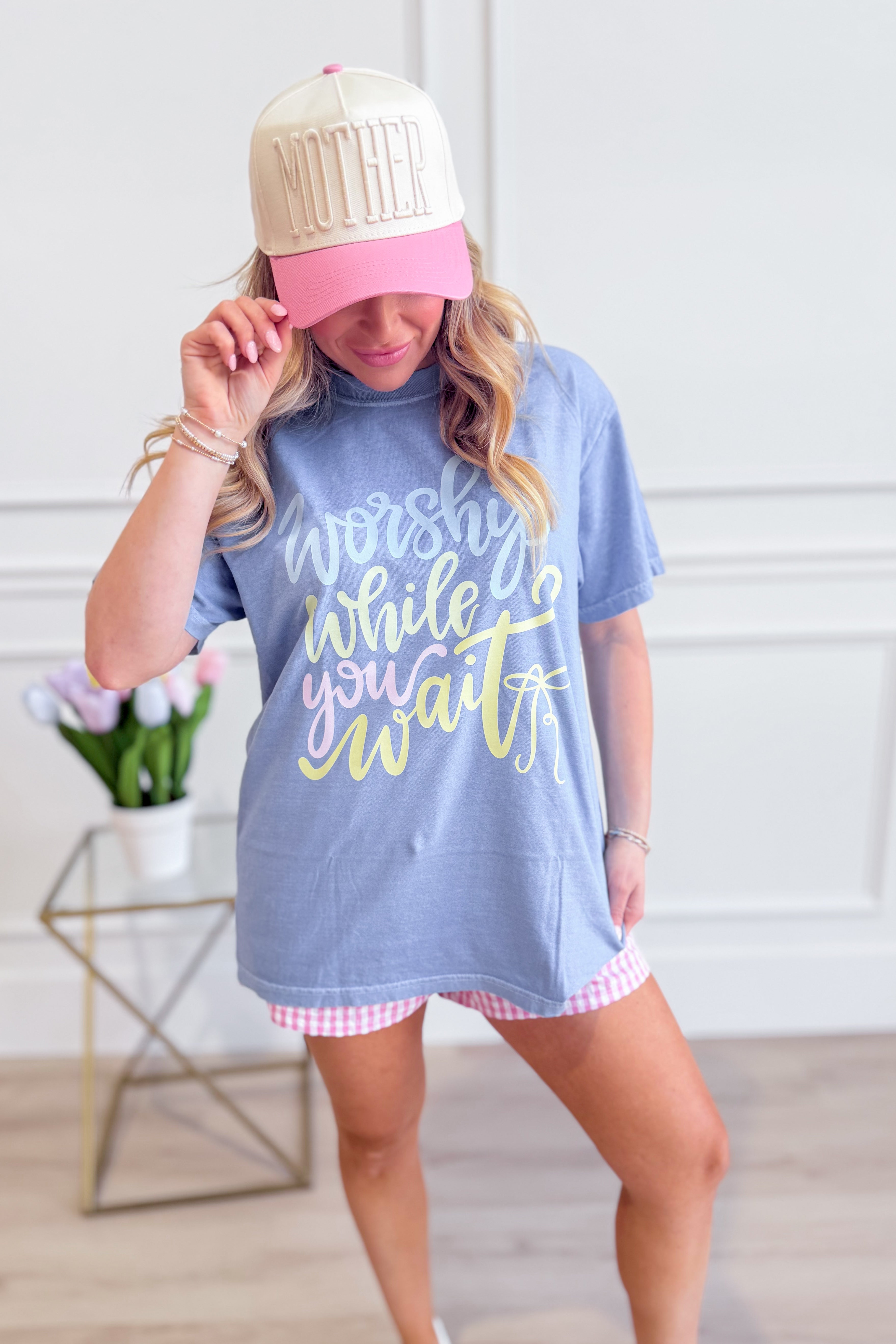 DASH FORWARD Worship While You Wait Graphic T-Shirt featuring bold text design on black fabric, casual fit, and short sleeves.