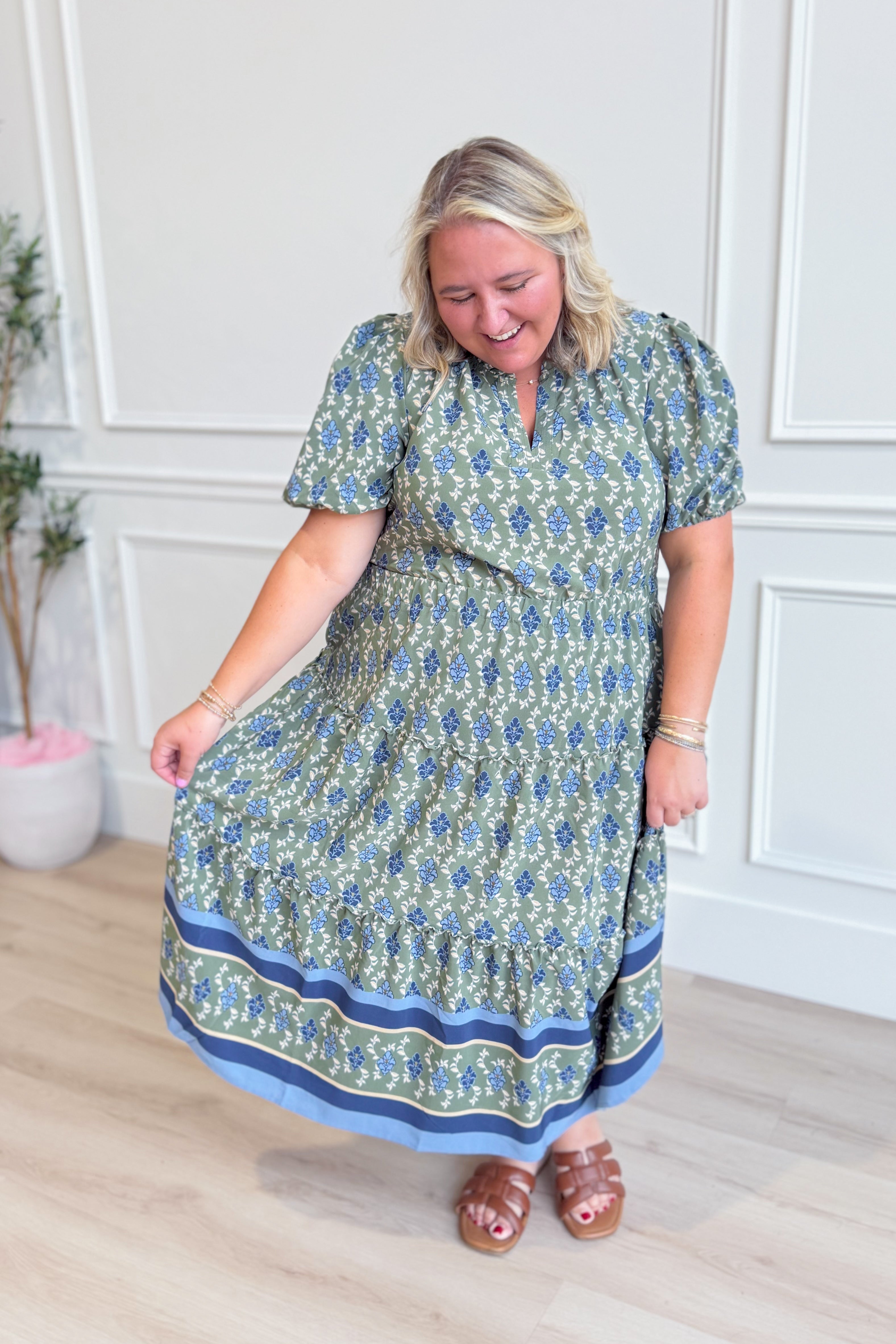 Mary Square Lainey floral puff sleeve midi dress with a fitted bodice and flowy skirt, featuring a vibrant floral pattern.