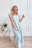 IN LOOM floral cotton maxi dress featuring a French-inspired floral pattern and flowing fabric, perfect for elegant summer occasions.