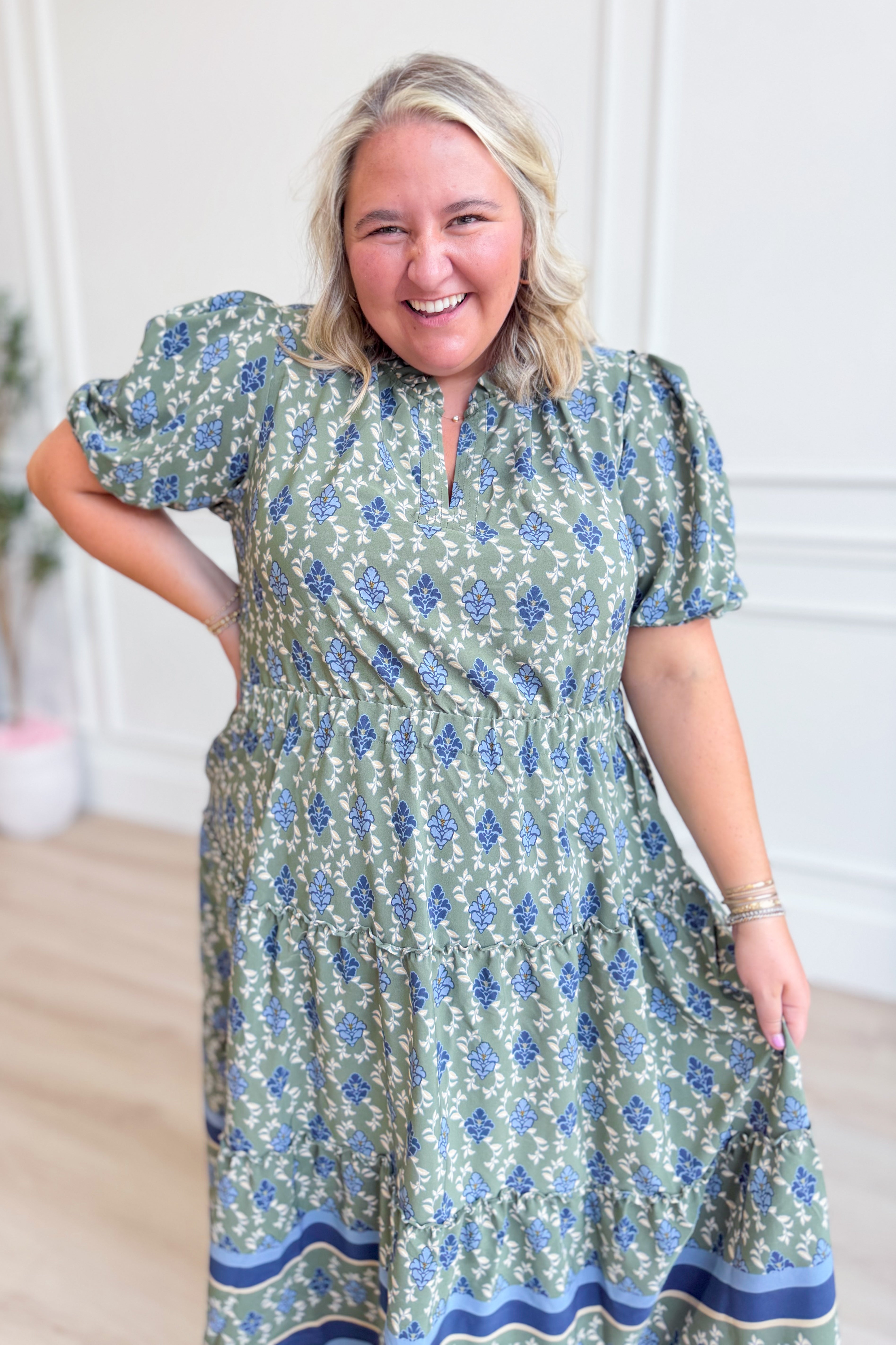 Mary Square Lainey floral puff sleeve midi dress with a fitted waist and flowing skirt, featuring a vibrant floral pattern.