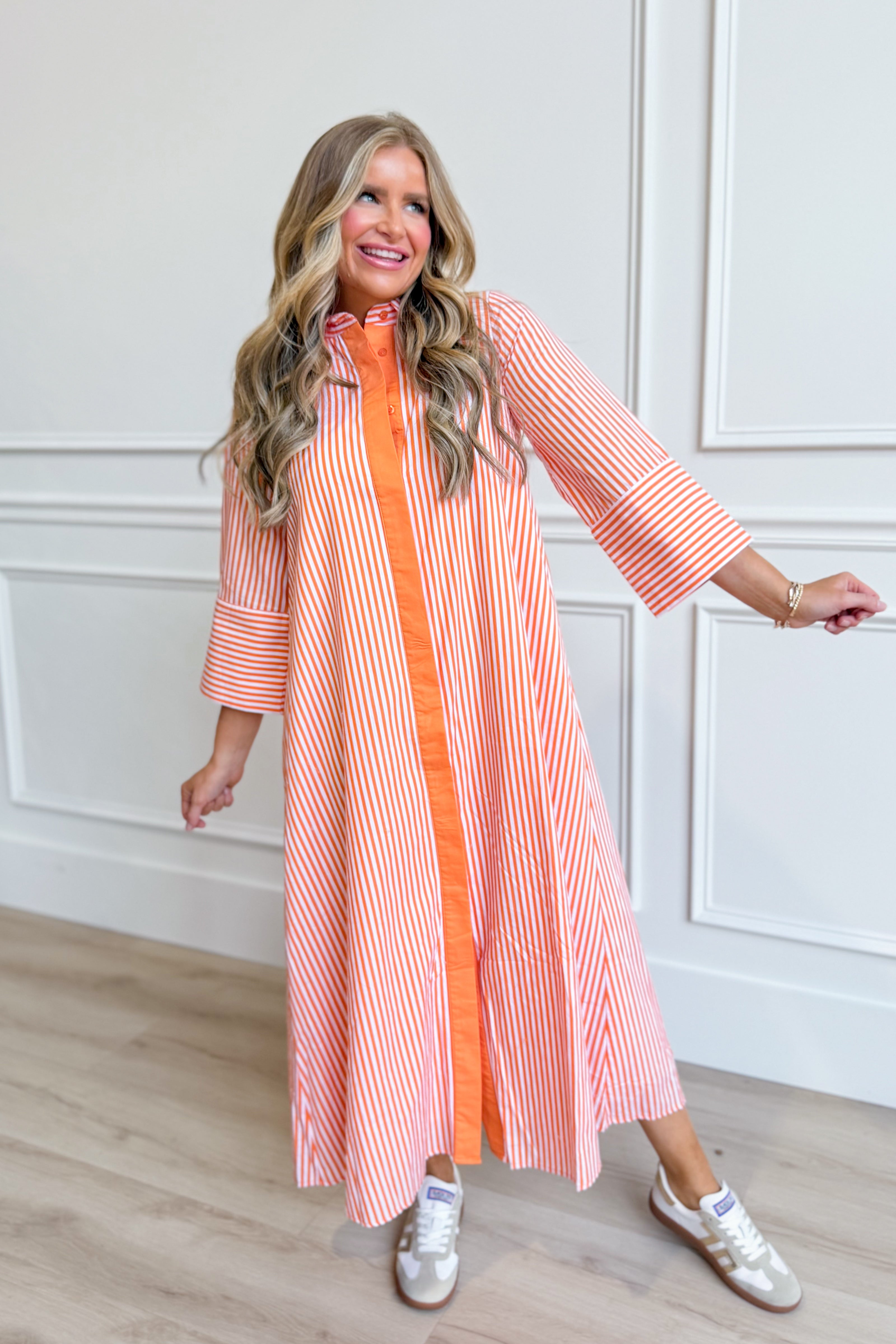 TCEC Aly striped button-down midi dress with long sleeves and a fitted waist, featuring bold vertical stripes.