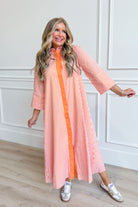 TCEC Aly striped button-down midi dress with long sleeves and a fitted waist, featuring bold vertical stripes.