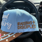 Broke Babe Motherhood Is My Ministry trucker hat with mesh back and embroidered text, stylish accessory for moms.
