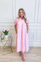 Umgée USA Tonya plaid printed midi dress with long sleeves and a fitted waist, featuring a stylish plaid pattern.