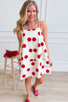 PEACH LOVE Jenna polka dot summer dress with sleeveless design and flowy fabric, perfect for warm weather occasions.