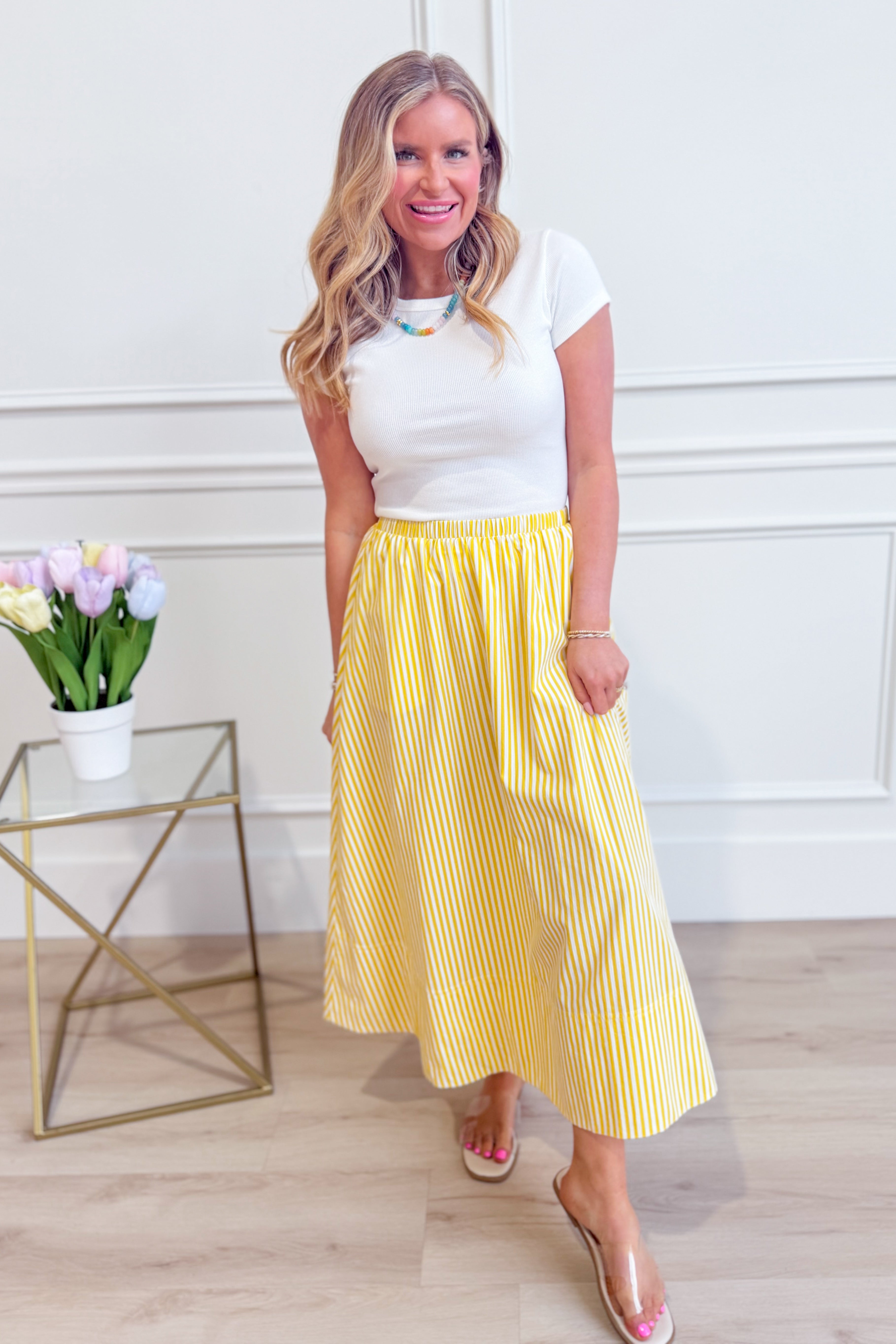 HYFVE Lola striped midi skirt with a fitted waistband and flowing hem, featuring bold vertical stripe patterns.