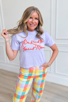Pink crop tee from POPPY & PINE with "Be Kind To Your Mom" graphic, casual style, displayed on a hanger.