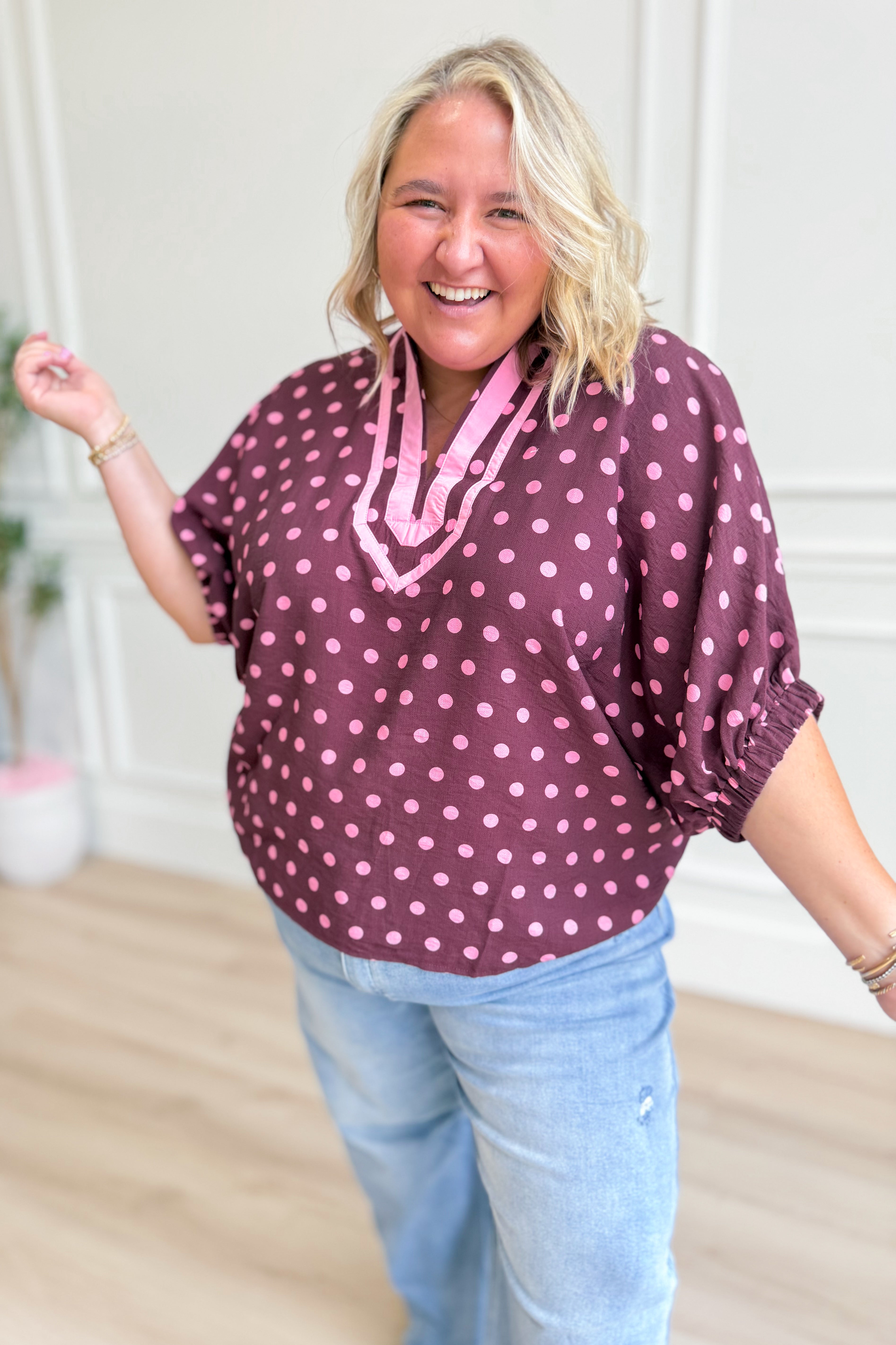 Emmie Polka Dot Split Neck Top by ENTRO, a stylish dressy blouse with polka dot pattern and split neckline, perfect for elegant casual wear.