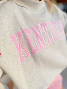 Kentucky Pink Striped Mock Embroidered Sweatshirt from BUCKET LIST, featuring pink stripes and embroidered details on a cozy graphic sweatshirt.