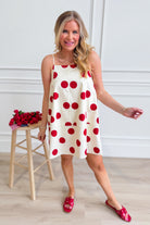 PEACH LOVE Jenna polka dot summer dress with sleeveless design and flowy fabric, perfect for warm weather occasions.