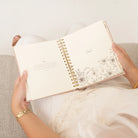 Undated Sonora 12-month planner by HOSANNA REVIVAL with a sleek cover, designed for organizing schedules and notes.
