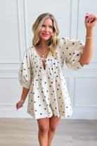 PEACH LOVE Loran Cream Pleated Polka Dot Romper with short sleeves and waist tie, featuring a vintage-inspired polka dot pattern.