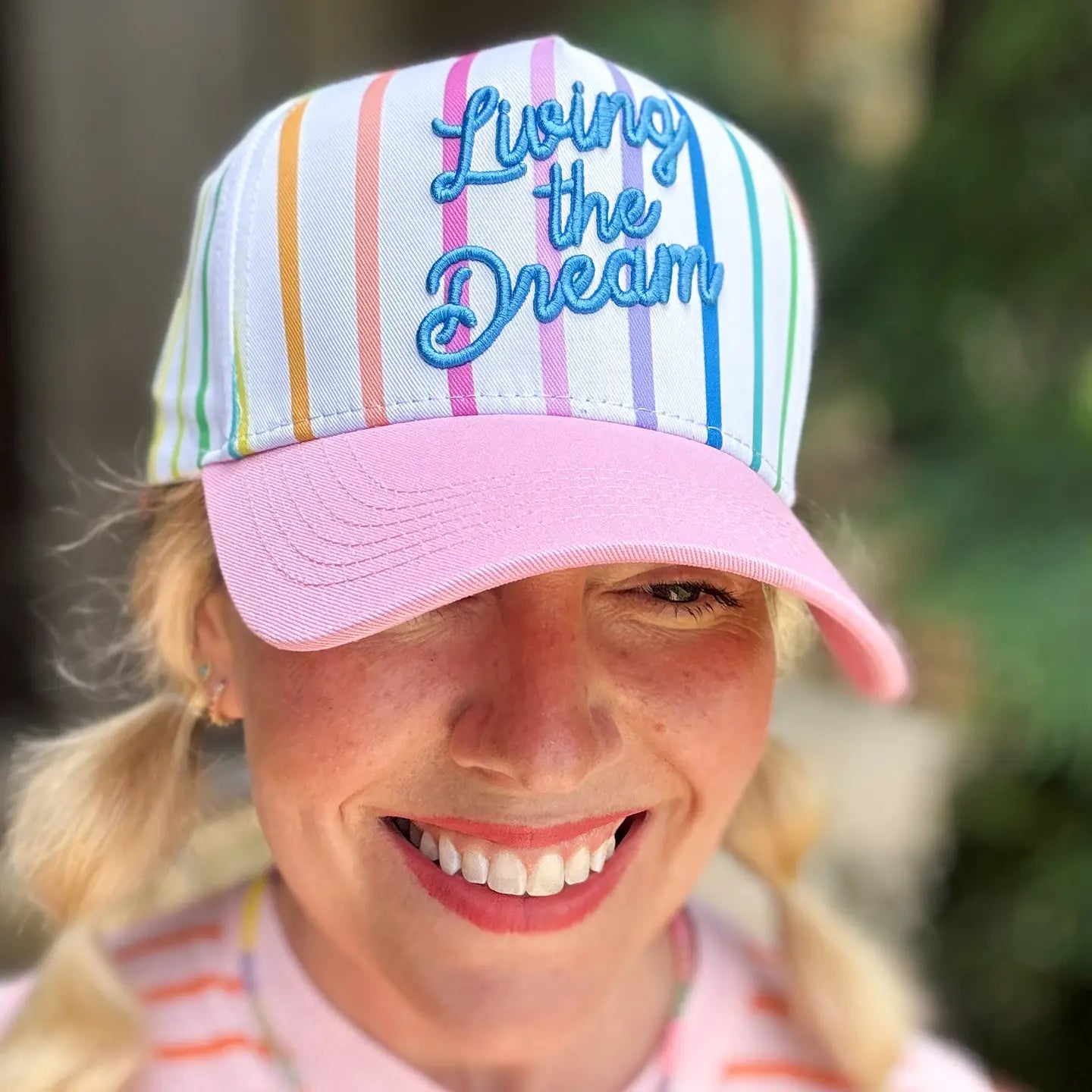 Living The Dream baseball hat by TAYLOR ELLIOT DESIGNS, featuring a classic design and embroidered logo, on a plain background.