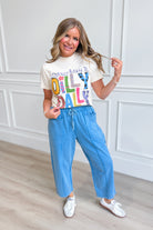 Popcorn-themed graphic T-shirt from POPPY & PINE featuring playful "Born To Dilly Dally" design on soft cotton fabric.