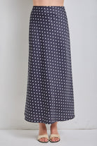 Black polka dot midi skirt from BAEVELY's Lucy collection, featuring a flowy design and classic pattern.