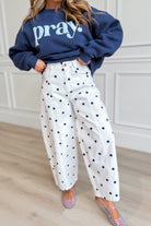 White polka dot barrel jeans from PEACH LOVE's Landry 147 Novelty Jeans collection, displayed with a relaxed fit and stylish design.