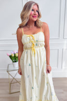 A WISHLIST Avery triple bow floral midi dress with a fitted bodice and flowing skirt, perfect for dressy occasions.