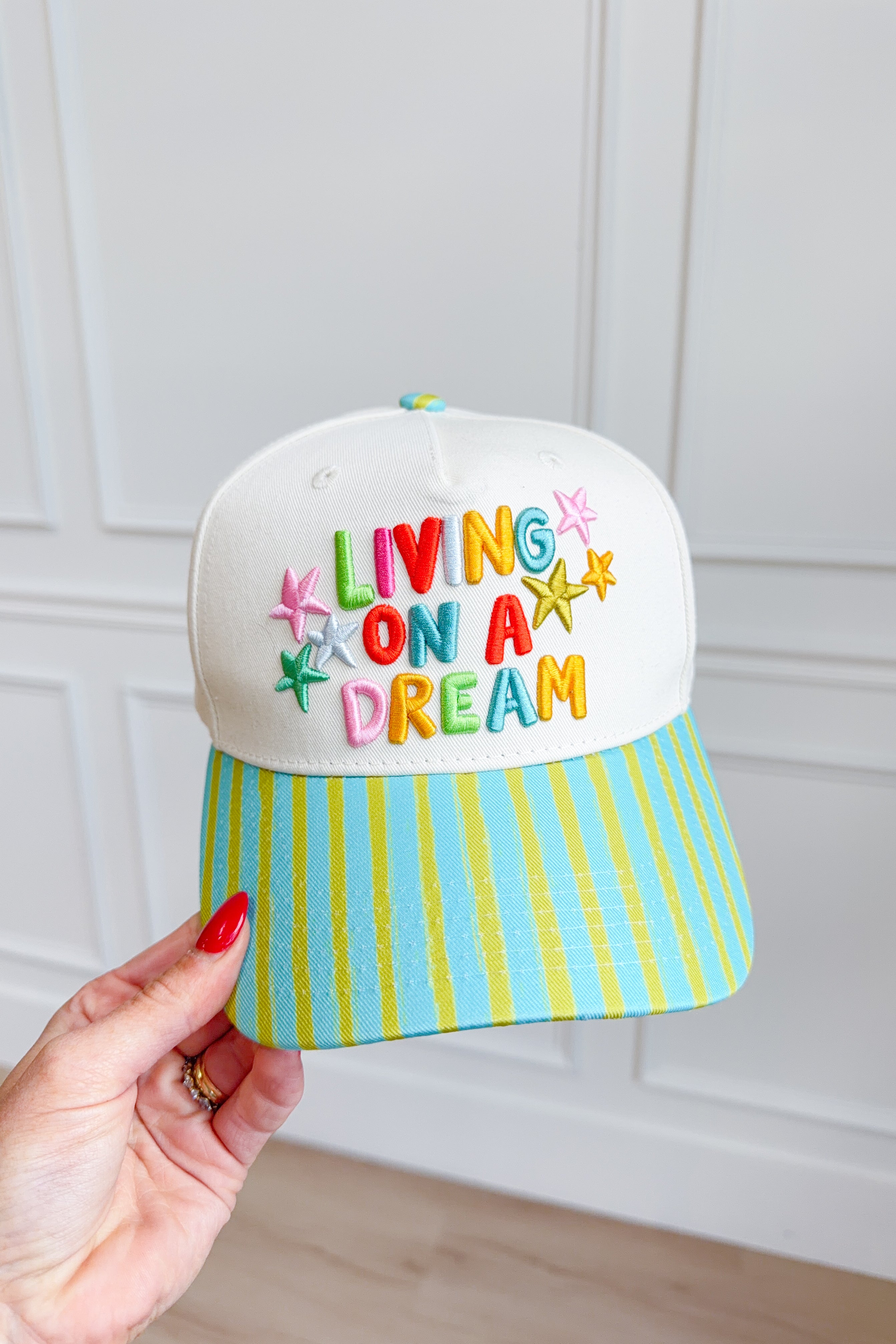 ETTA & EAST Living On A Dream trucker hat with mesh back and embroidered front design, casual and stylish hair accessory.