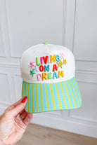 ETTA & EAST Living On A Dream trucker hat with mesh back and embroidered front design, casual and stylish hair accessory.