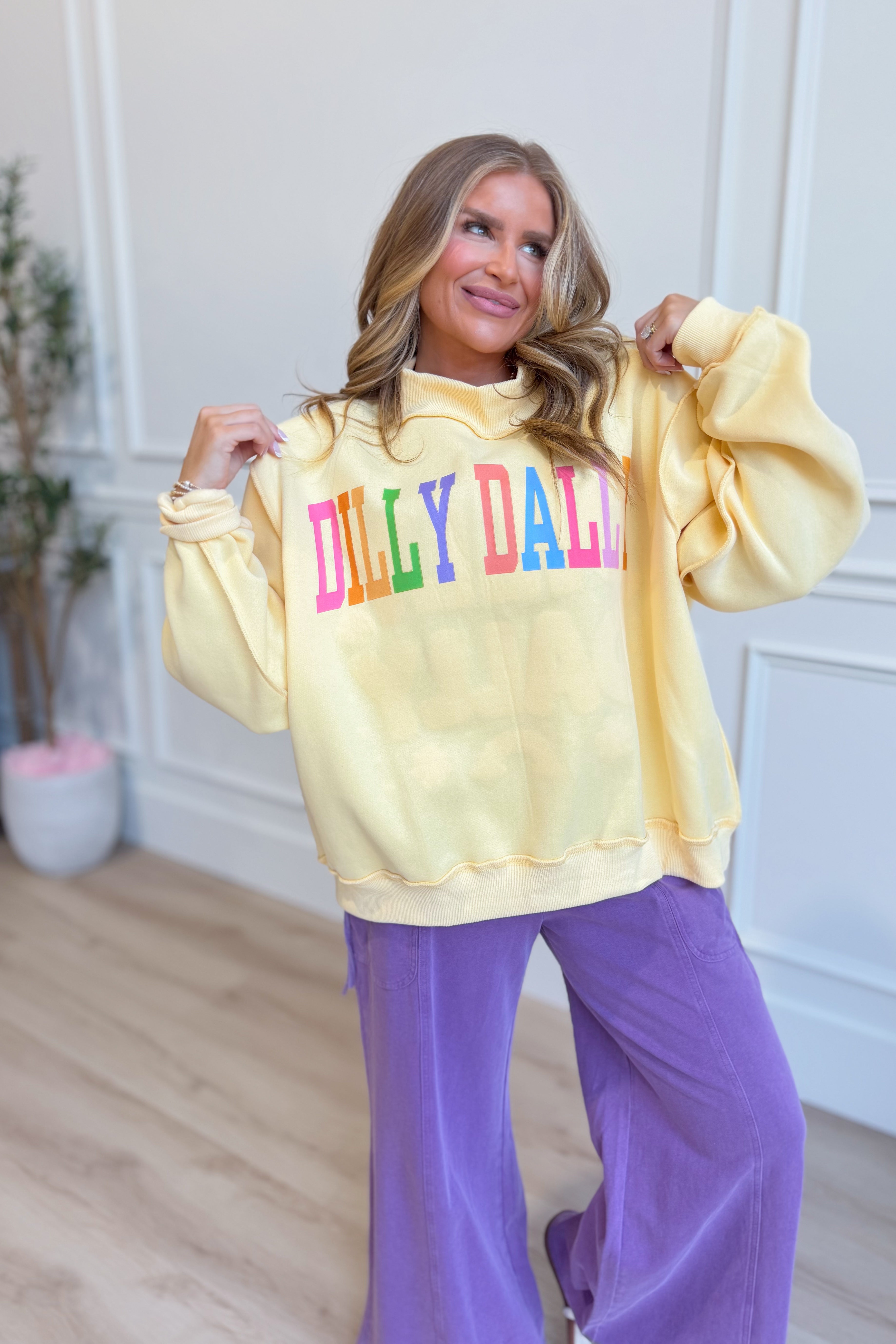 Dilly Dally Rainbow Reversible Mock Neck Sweatshirt from BUCKET LIST, featuring vibrant rainbow graphic on a cozy sweatshirt.