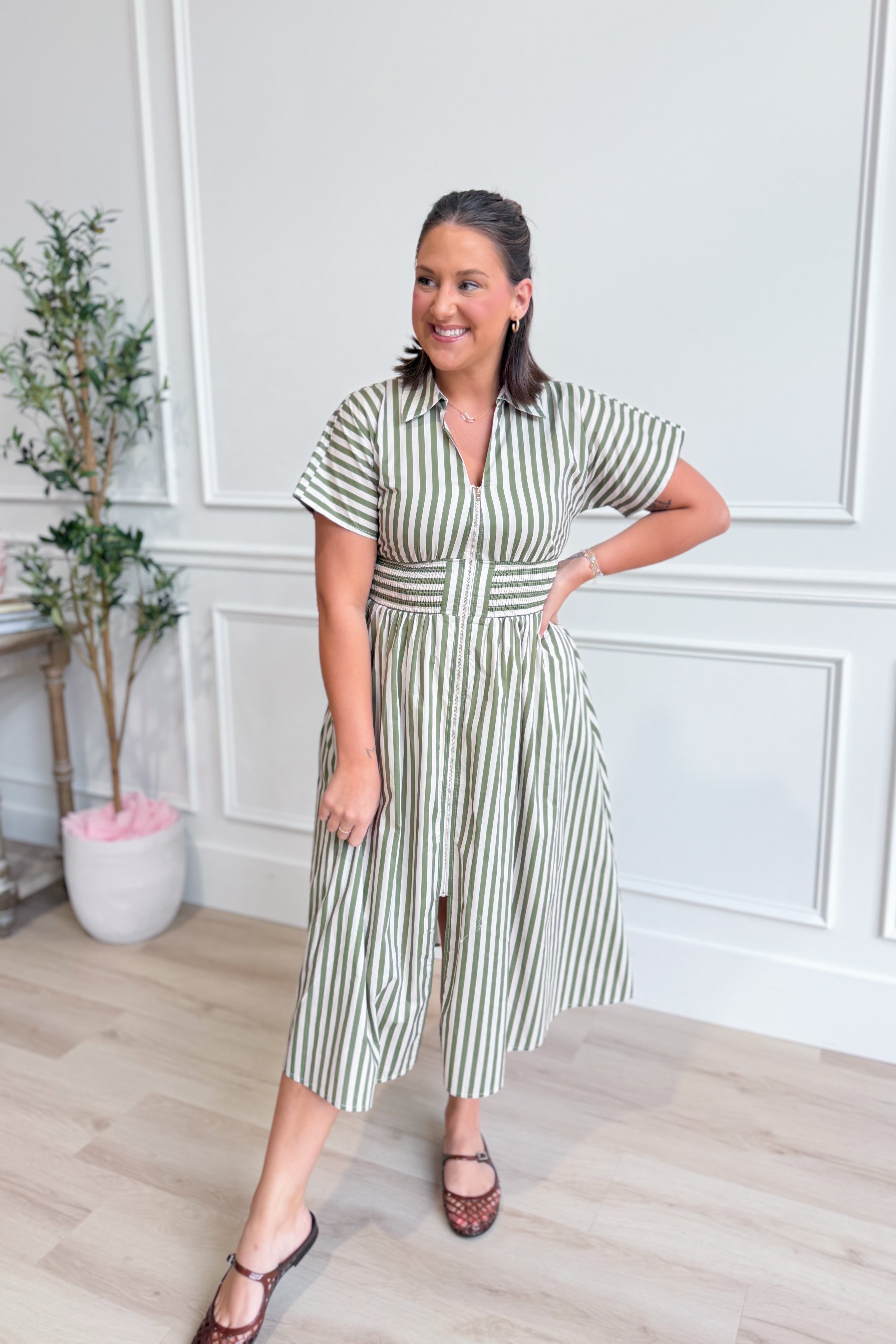 Kristen Olive Striped Zip Up Midi Dress by ENTRO featuring a fitted silhouette, olive green and white stripes, and a front zipper detail.