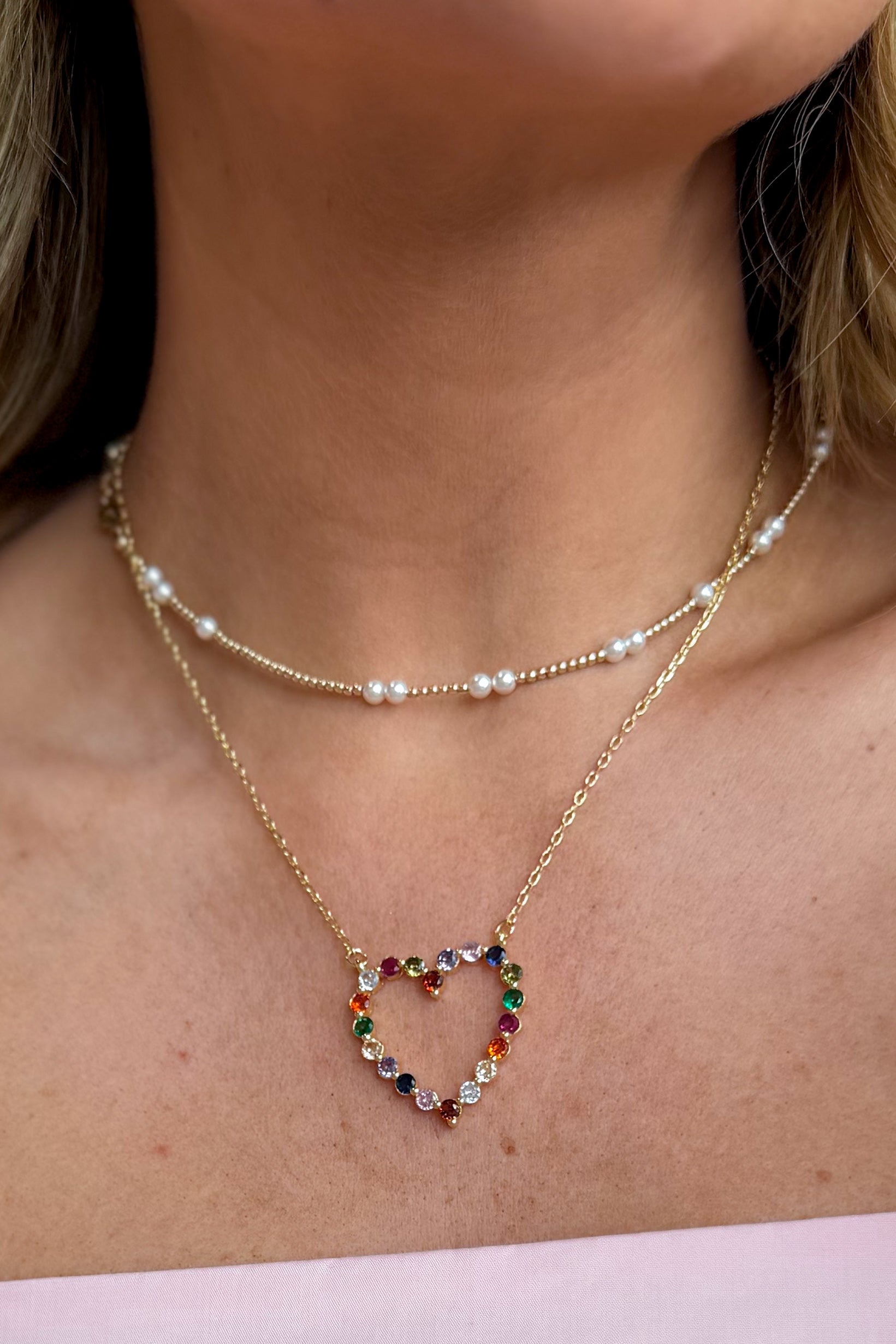 Sparkle multi-heart necklace by Treasure Jewels featuring shimmering jewelry with various heart-shaped pendants on a delicate chain.