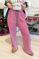 Rudy Red Striped Holiday Pants by BUCKET LIST, stylish 156 pants with festive red and white stripes for holiday wear.