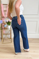 Risen Stevie high-rise crop wide-leg tummy control jeans in blue denim, with visible stitching and classic five-pocket design.