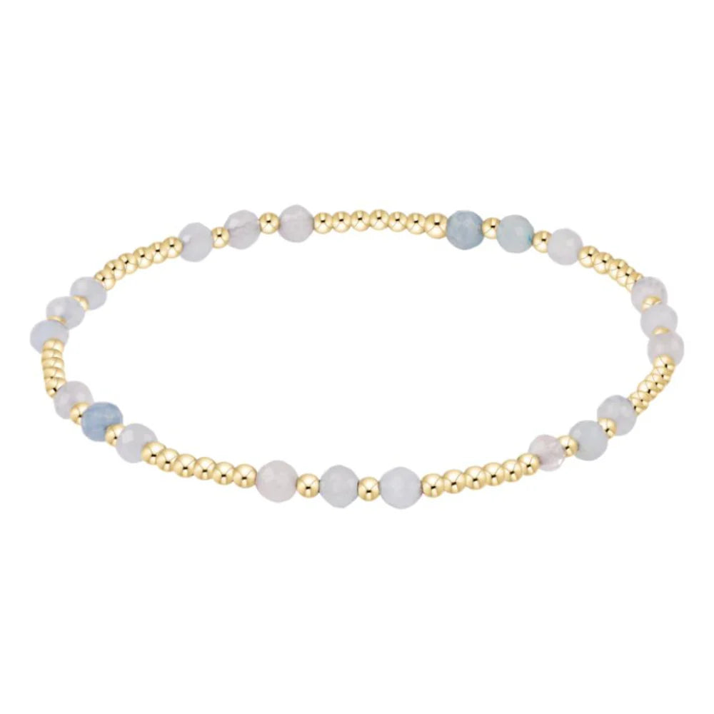 Enewton Aquamarine and gold Joy Gem bracelet with intricate design and gemstone accents, showcasing elegant jewelry craftsmanship.