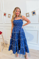 Vicki Polka Dot Tiered Midi Dress by PEACH LOVE, featuring a flowy, tiered design with black and white polka dots.