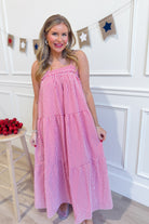 Red gingham printed maxi dress by PEACH LOVE, featuring a flowy design and dressy style for elegant occasions.
