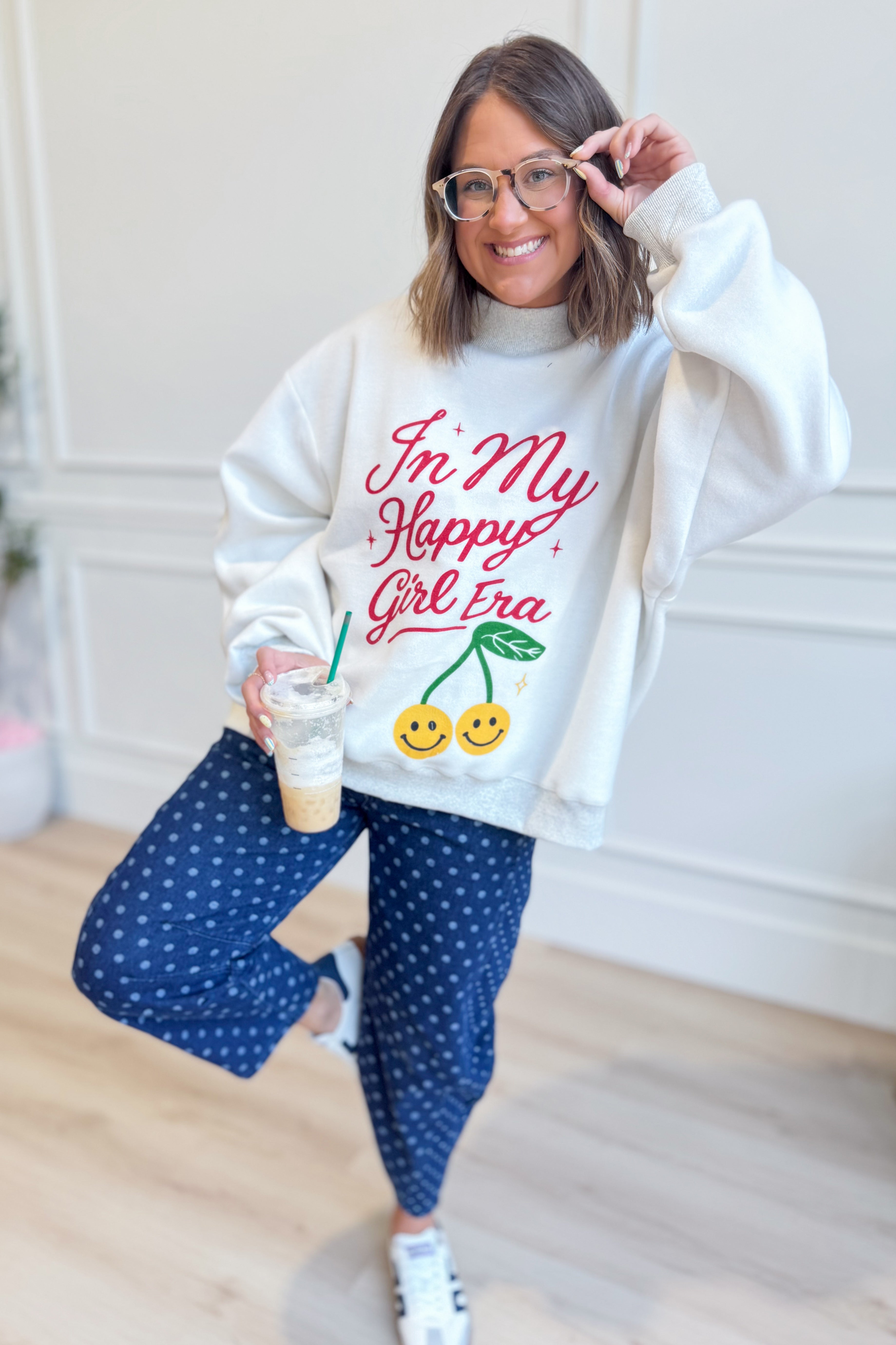 Reversible "In My Happy Girl Era" graphic sweatshirt by BUCKET LIST, featuring vibrant colors and casual fit.