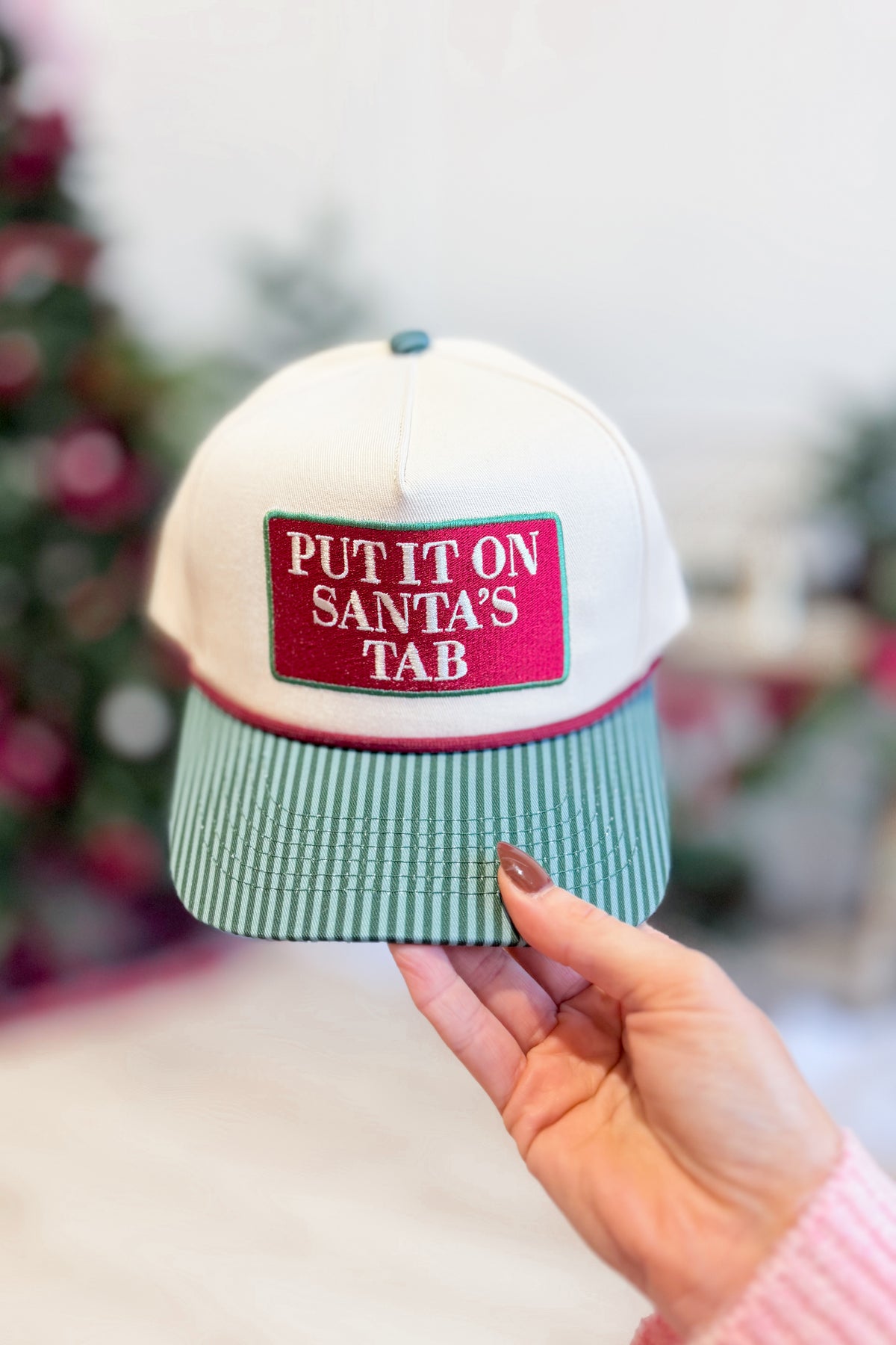 Put It On Santa's Tab Hat by SUMMER TEES, a festive red accessory with a playful design, perfect for holiday costumes and parties.