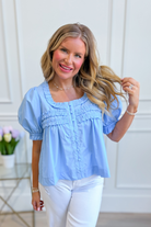 Light blue puff sleeve frilly top by ENTRO, stylish dressy blouse with ruffled details and a feminine silhouette.