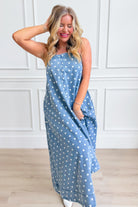Aureum Mia polka dot denim dress with a fitted bodice and flared skirt, featuring classic polka dot pattern and stylish design.