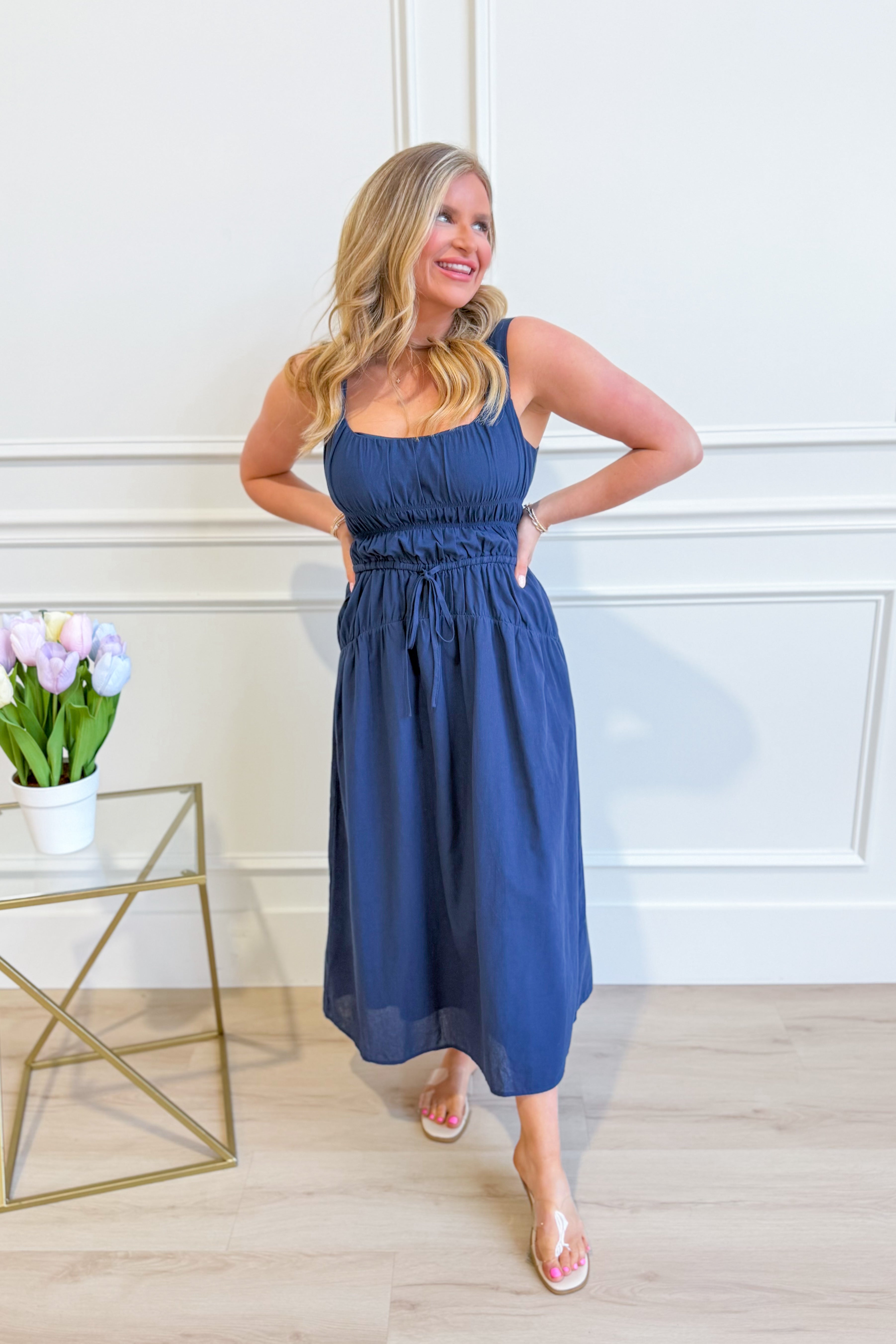 Baevely Cindy smocked tie waist midi dress in a flowy fabric, featuring a relaxed fit and elegant design for dressy occasions.