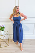 Baevely Cindy smocked tie waist midi dress in a flowy fabric, featuring a relaxed fit and elegant design for dressy occasions.