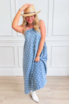 Aureum Mia polka dot denim dress with a fitted bodice and flared skirt, featuring classic polka dot pattern and sleeveless design.