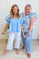 Light blue puff sleeve frilly top from ENTRO, stylish and dressy, with ruffled details and a feminine fit.