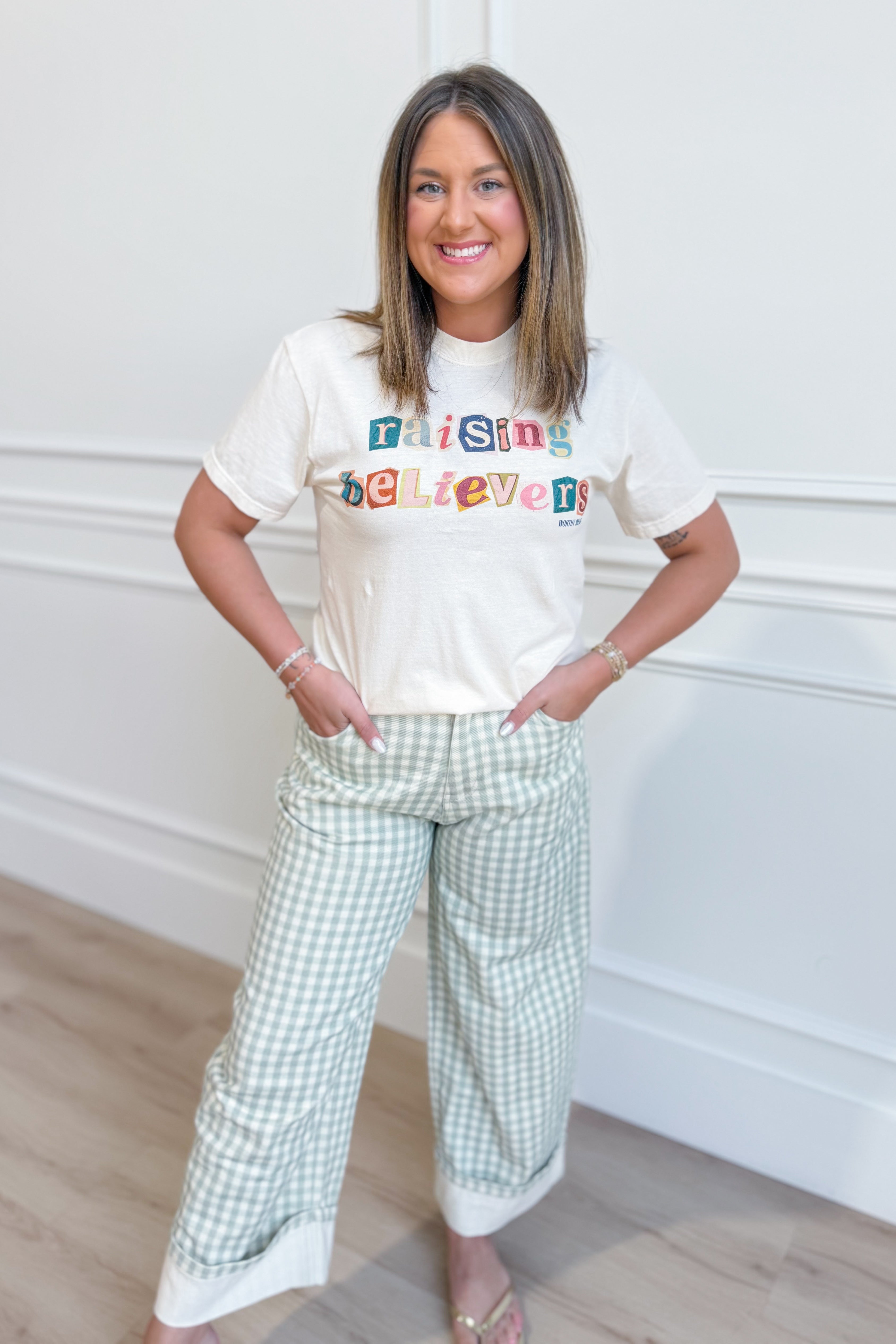Raising Believers graphic T-shirt by Worthy Wear, featuring a vibrant design on a casual crewneck tee with bold lettering.