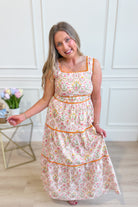 IN LOOM Miracle Cotton floral square neck maxi dress displayed on a hanger with a vibrant floral pattern and flowing silhouette.