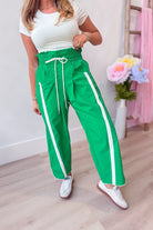 Lenny Windbreaker Contrasted Stripe Pant from BUCKET LIST, 156 pants, showing black windbreaker fabric with white contrasting stripes.