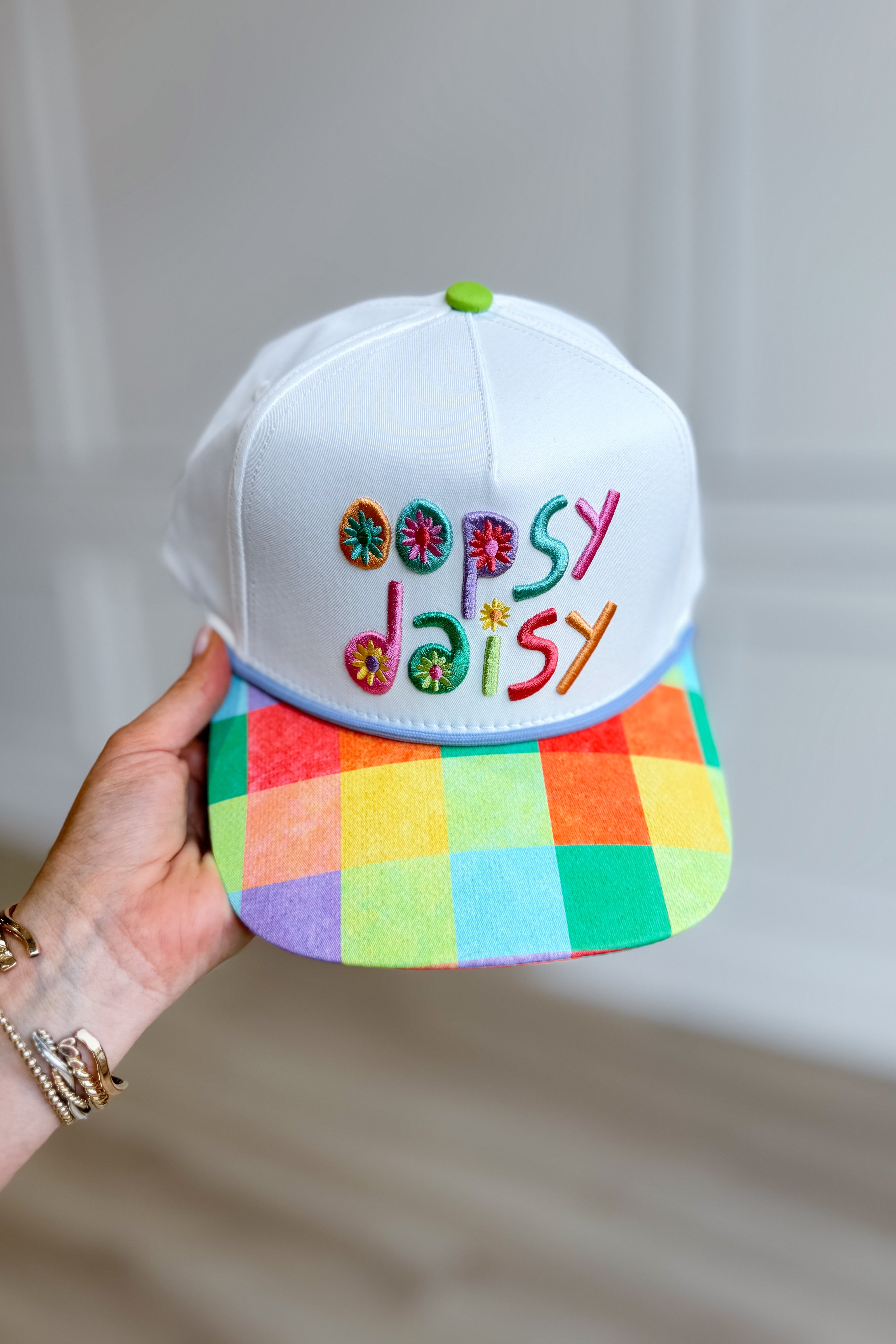 Colorful floral Oopsy Daisy hat from POPPY & PINE, designed as a stylish hair accessory with vibrant flower details.