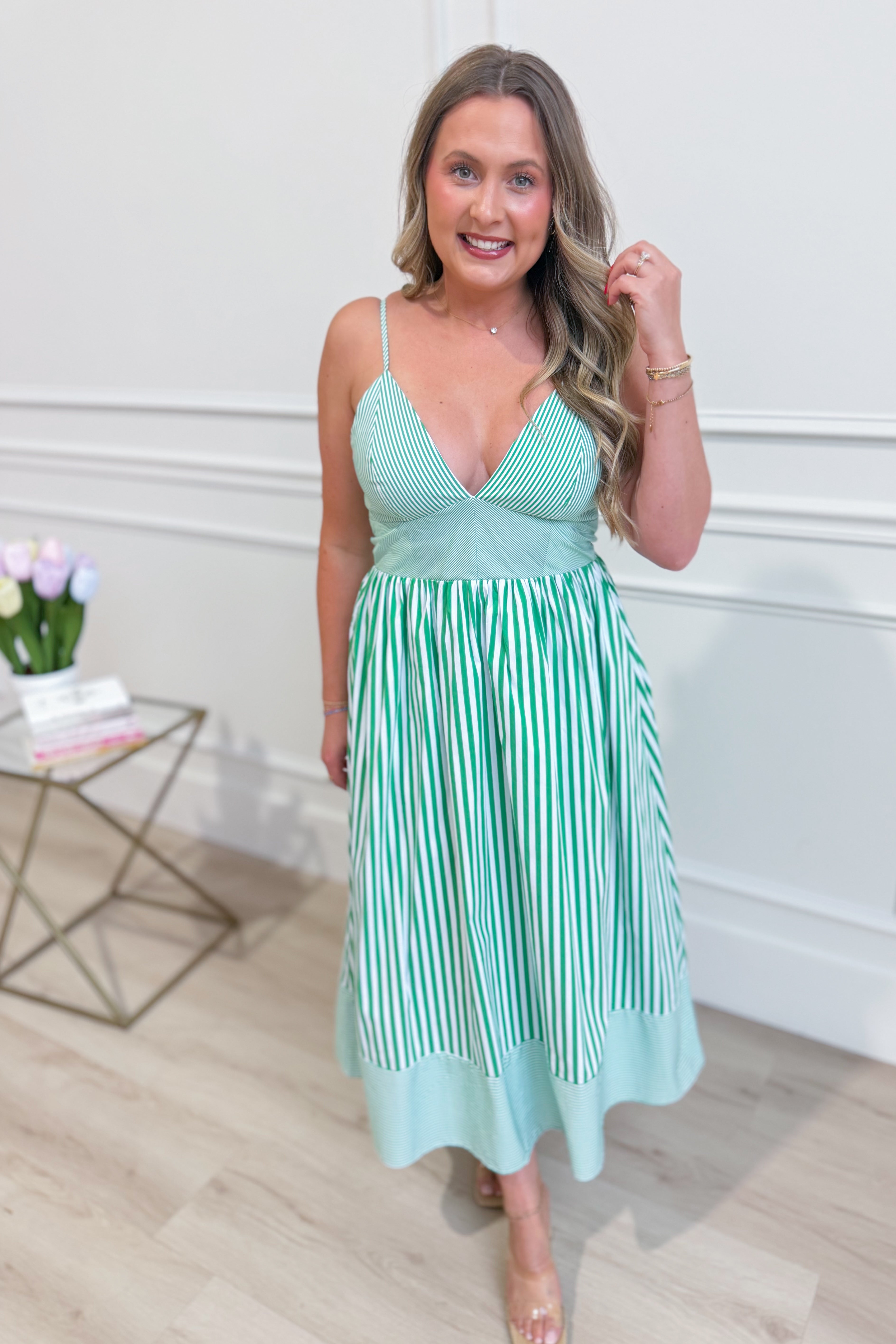 TCEC Peter striped sleeveless midi dress with casual style, featuring a fitted waist and knee-length skirt, on a model.